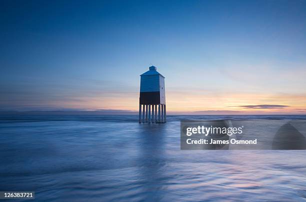 burnham-on-sea lighthouse at high tide at dusk. somerset. england. uk. - burnham on sea stock pictures, royalty-free photos & images