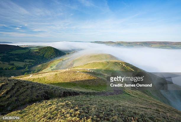 mist over church stretton from caer caradoc with long mynd in the distance. shropshire. england. uk. - shropshire stock pictures, royalty-free photos & images