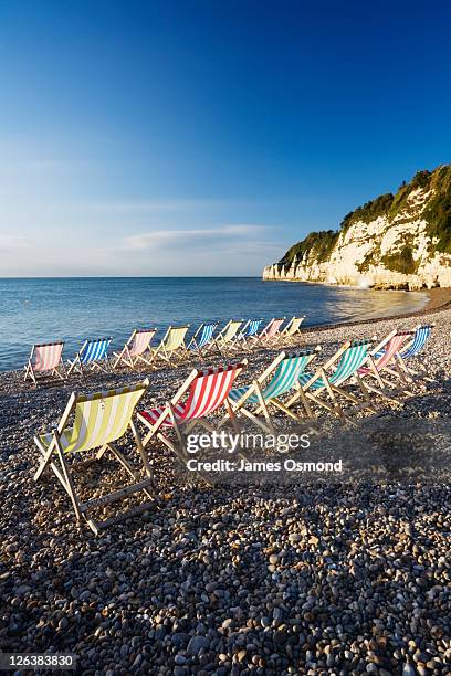 deckchairs on beer beach, devon, england, uk - jurassic coast world heritage site stock pictures, royalty-free photos & images