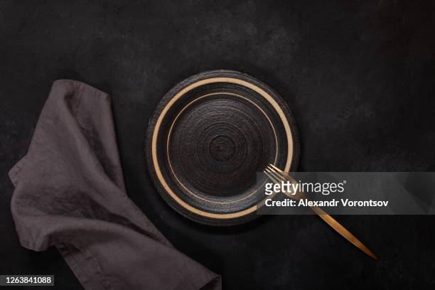 dark dishes on black background - napkin stock pictures, royalty-free photos & images