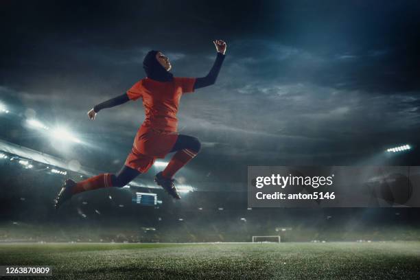 female football or soccer player at stadium - motion, action, activity concept - womens champions league stock pictures, royalty-free photos & images