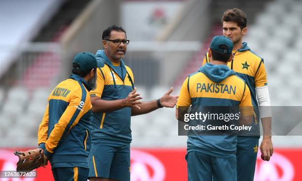 Coach Waqar Younis speaks to the Pakistan bowlers during a Pakistan Nets Session at Emirates Old Trafford on August 04, 2020 in Manchester, England.