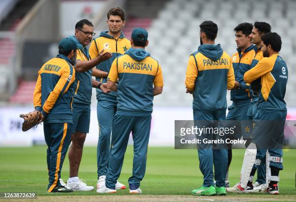 Coach Waqar Younis speaks to the Pakistan bowlers during a Pakistan Nets Session at Emirates Old Trafford on August 04, 2020 in Manchester, England.