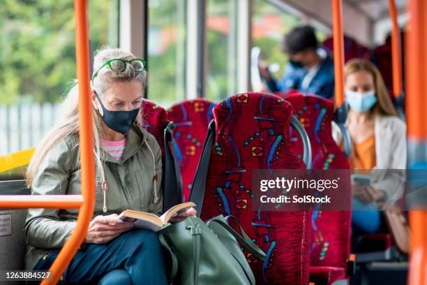 the daily routine during covid 19 - commuter mask stock pictures, royalty-free photos & images