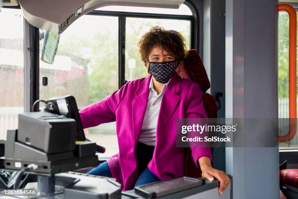 bus driver wearing a protective mask - bus driver stock pictures, royalty-free photos & images