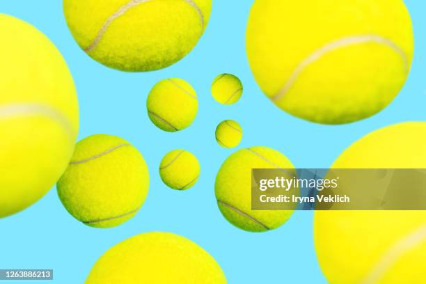 trendy tennis balls levitation on blue green mint background. - blue tennis racket stock pictures, royalty-free photos & images