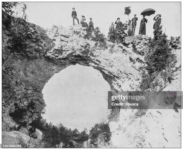 antique black and white photograph: arch rock, mackinac island - mackinac bridge stock illustrations