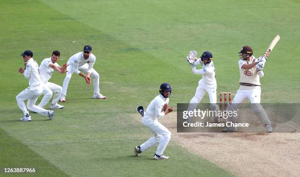 Rikki Clarke of Surrey bats as Nick Gubbins, Nathan Sowter, Stephen Eskinazi, Max Holden and John Simpson, Wicketkeeper of Middlesex field during Day...