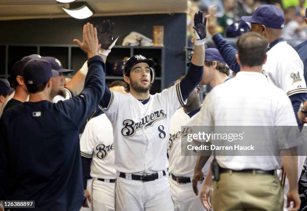 Ryan Braun of the Milwaukee Brewers is congratulated by team mates after hitting a home run against the Florida Marlins in the fourth inning at a...