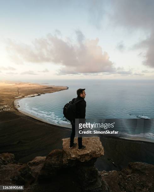 man standing on the rock and looking at sea view, la palma, canary islands, spain - la palma islas canarias stock pictures, royalty-free photos & images