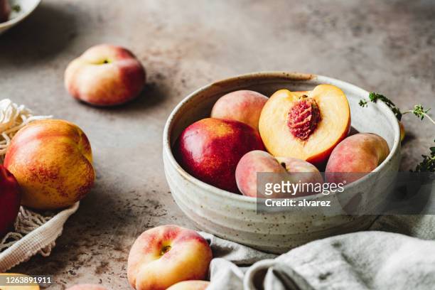 ripe peaches in a bowl - ripe stock pictures, royalty-free photos & images