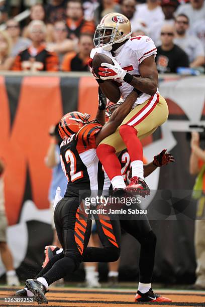 Michael Crabtree of the San Francisco 49ers catches an apparent touchdown pass over the defense of Chris Crocker of the Cincinnati Bengals and Leon...