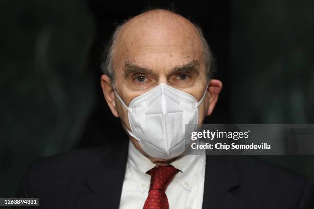 Wearing a face mask to reduce the risk posed by the novel coronavirus, State Department Special Representative for Venezuela Elliot Abrams prepares...