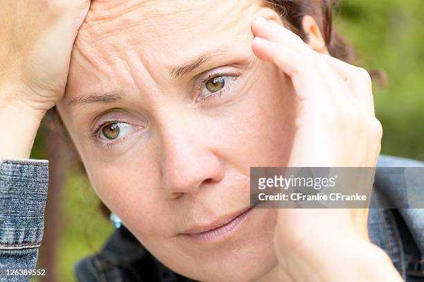 close-up of woman thinking - 40 44 jahre 個照片及圖片檔
