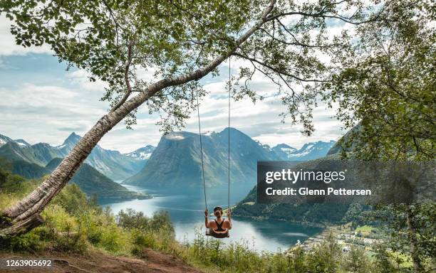 woman swinging into nature in norway. - norge stock pictures, royalty-free photos & images