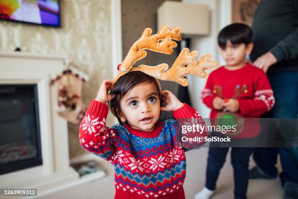 dressing up as a reindeer - christmas jumper stock pictures, royalty-free photos & images