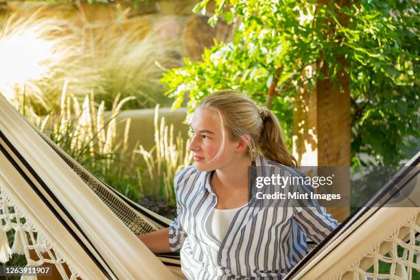 portrait of 11 year old girl in hammock at sunset - 12 year old blonde girl stock-fotos und bilder