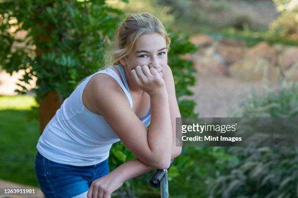 portrait of 11 year old  girl on scooter - 13 year old girls in shorts stock pictures, royalty-free photos & images