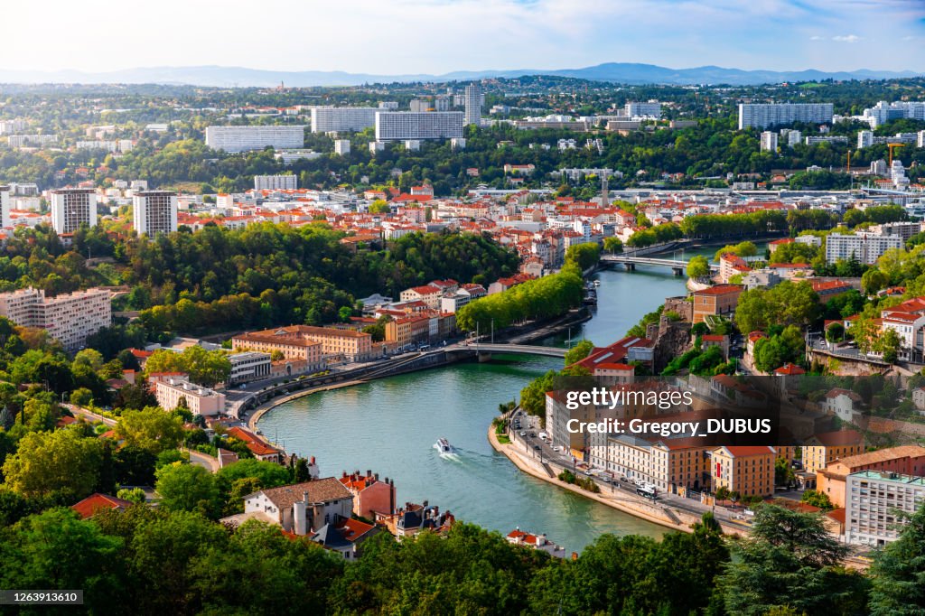 Aerial view of the suburbs of Lyon French city along Saone river with some residential buidings and boats sailing