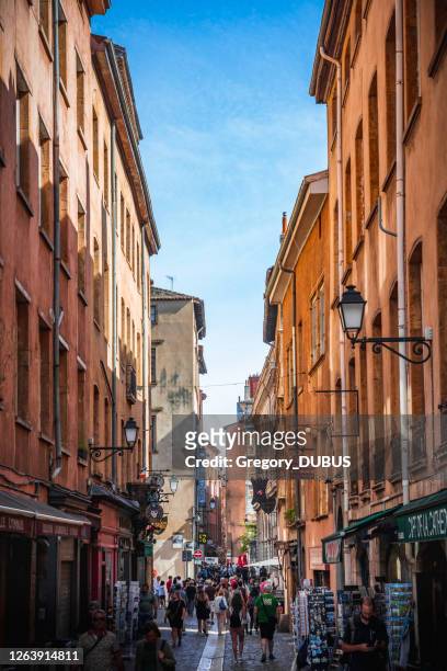 crowd of tourists walking through the streets of lyon french old city district near the cathedral of st jean - lyon shopping stock pictures, royalty-free photos & images