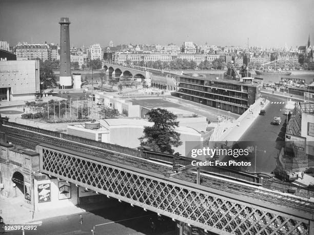 General view looking towards the South Bank, with the Shot Tower on the site of Lambeth Lead Works, beside Royal Festival Hall , with a rail line...