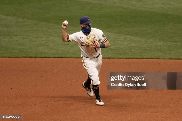 Brock Holt of the Milwaukee Brewers throws second base in the ninth inning against the Chicago White Sox at Miller Park on August 03, 2020 in...