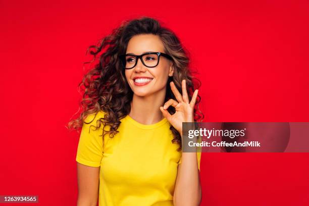 attractive smiling young woman - yellow shirt stock pictures, royalty-free photos & images