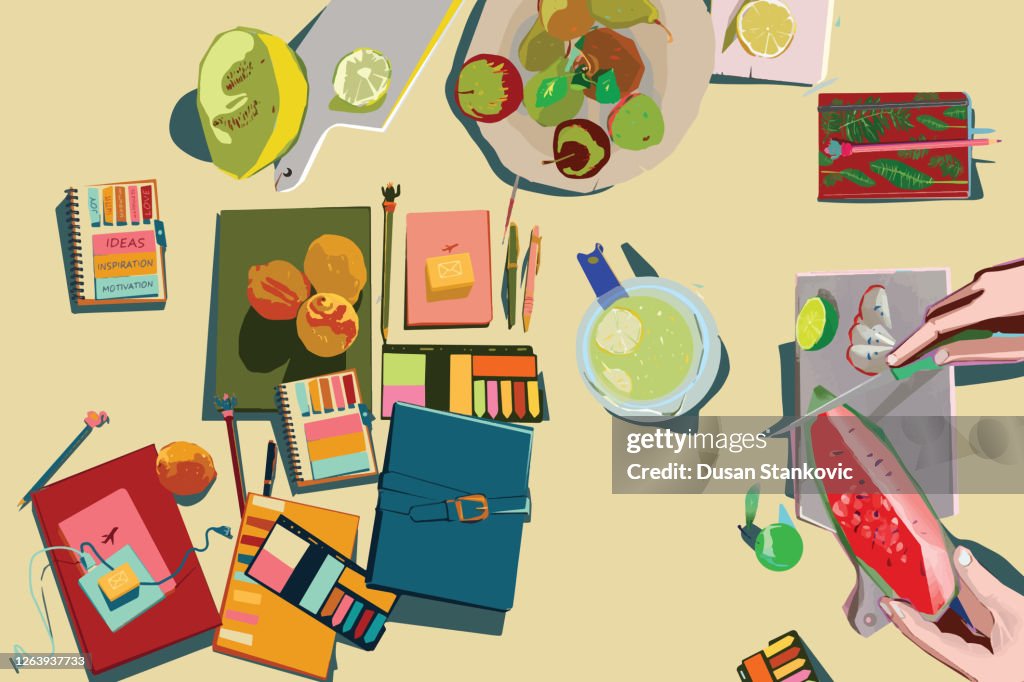 Illustration of a home office desk with a notebook, notes, sticky notes, pens, and fruit refreshment