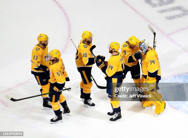 Juuse Saros and Filip Forsberg of the Nashville Predators celebrate the win with the rest of their teammates after the 4-2 win over the Arizona...