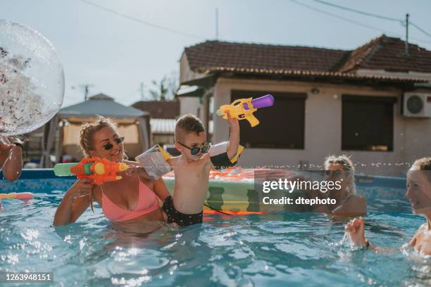 pool party - hot moms club stock pictures, royalty-free photos & images