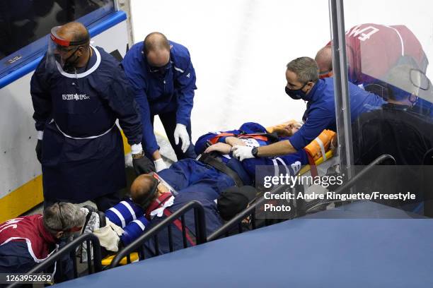 Jake Muzzin of the Toronto Maple Leafs is carried off the ice during the third period in Game Two of the Eastern Conference Qualification Round prior...