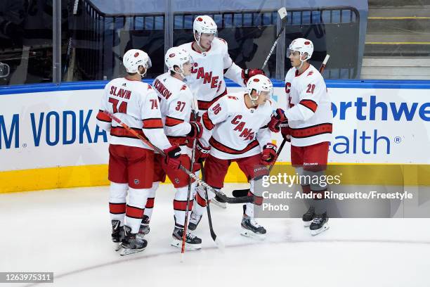 Teuvo Teravainen of the Carolina Hurricanes celebrates with his teammates after scoring a goal on Igor Shesterkin of the New York Rangers during the...