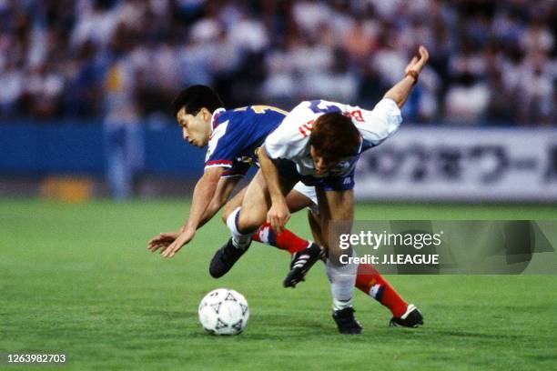 Masakiyo Maezono of Yokohama Flugels and Kazushi Kimura of Yokohama Marinos compete for the ball during the J.League Suntory Series match between...