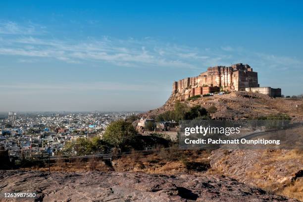 view of mehrangarh fort and jodhpur city seen from a hill top on a sunny day with blue sky in jodhpur, india - jodhpur stock pictures, royalty-free photos & images