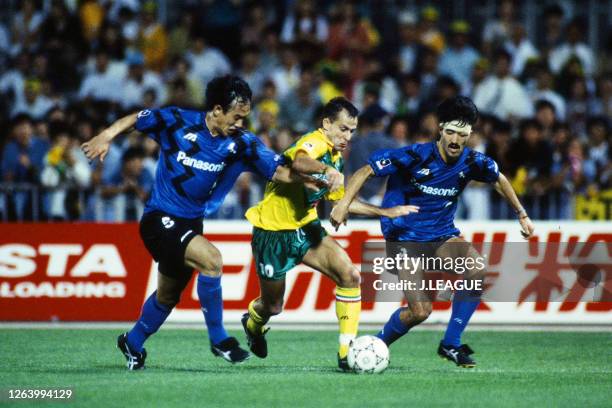 Pierre Littbarski of JEF United Ichihara competes for the ball against Hiroki Azuma and Naohiko Minobe of Gamba Osaka during the J.League Suntory...