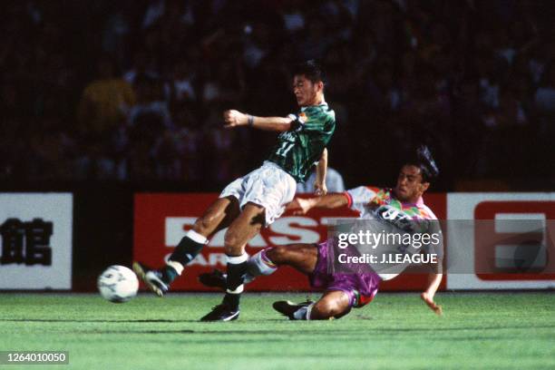 Nobuhiro Takeda of Verdy Kawasaki is tackled by Mitsuaki Kojima of Sanfrecce Hiroshima during the J.League Suntory Series match between Verdy...