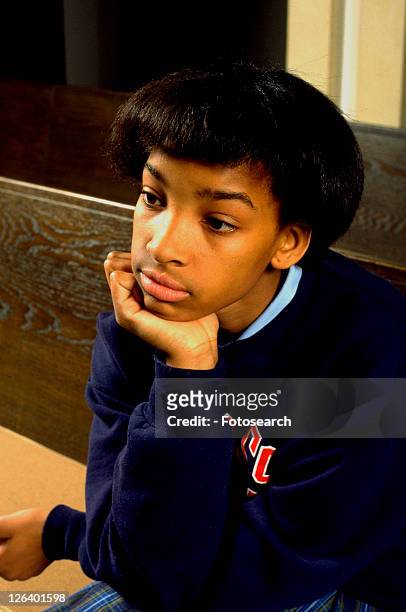 girl age 13 thinking in church pew with chin in hand - junior girl models stock pictures, royalty-free photos & images