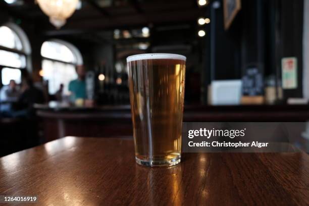 pint of craft beer - beer on table stock pictures, royalty-free photos & images