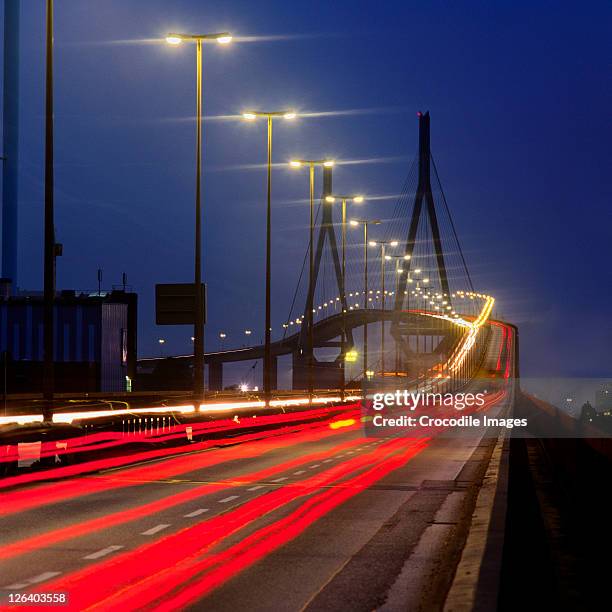 high angle view of traffic in motion at night, germany - köhlbrandbrücke stock pictures, royalty-free photos & images