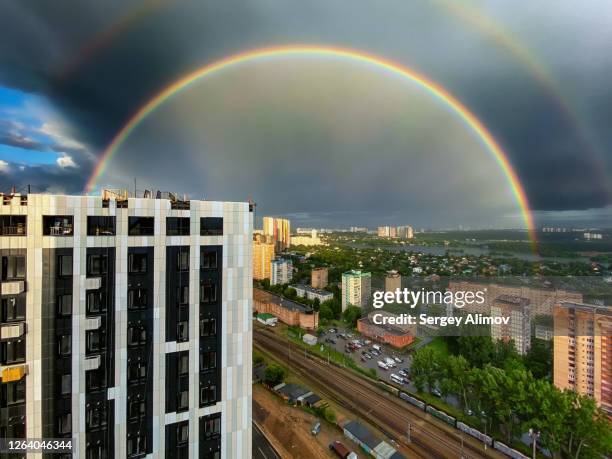 bright semicircle of rainbow over summer cityscape - krasnogorsky district moscow oblast stock pictures, royalty-free photos & images