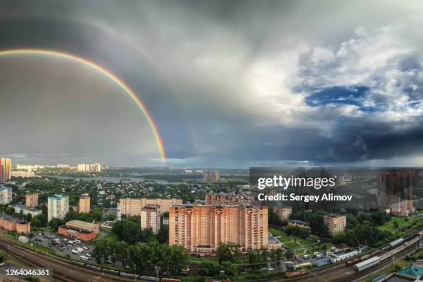 aerial view of rainbow semicircle and gloomy sky after summer storm - krasnogorsky district moscow oblast stock pictures, royalty-free photos & images