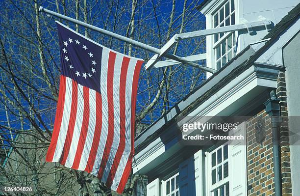 original 13 colony flag flying outside home - pennsylvania colony flag - fotografias e filmes do acervo