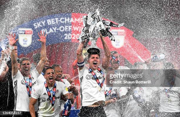 Tom Cairney of Fulham lifts the trophy as the team celebrate victory after the Sky Bet Championship Play Off Final match between Brentford and Fulham...