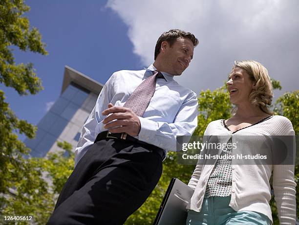 low angle view of businessman and businesswoman smiling - 40 44 jahre fotografías e imágenes de stock