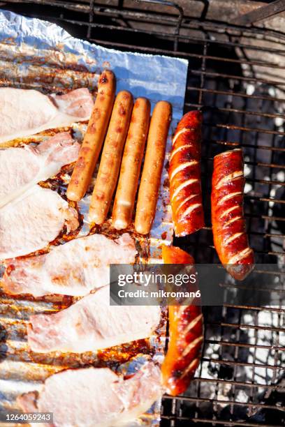 bbq with bacon sausages on top. - vegan sausage stock pictures, royalty-free photos & images