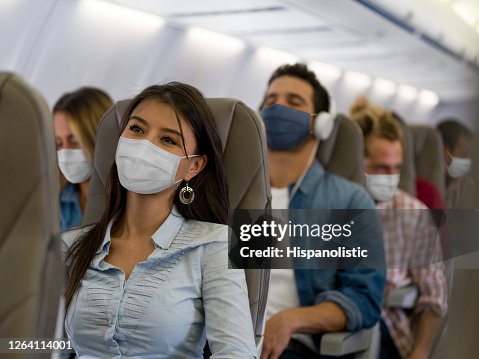Woman traveling by plane wearing a facemask Woman traveling by plane wearing a facemask