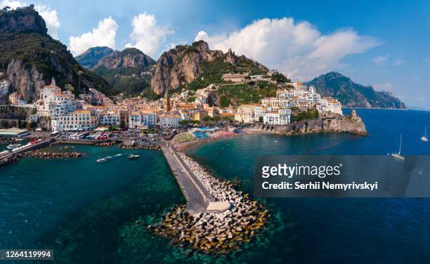 aerial view from the sea of the amalfi coast with amalfi city, summer day. travel and vacation to europe mountains. boats and ships, the most popular beach. breakwater. houses and hotels. italy - sorrento italy photos et images de collection
