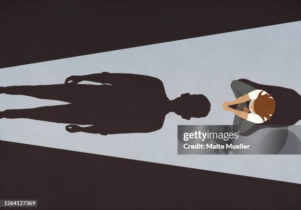 stockillustraties, clipart, cartoons en iconen met woman sitting before looming male shadow - onheilspellend