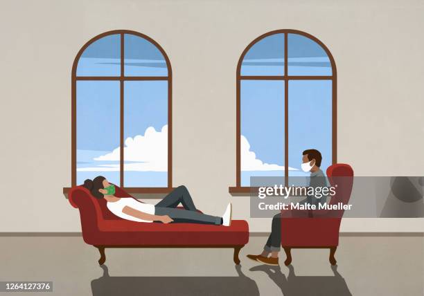 therapist and patient in face masks talking in office - liegen stock-grafiken, -clipart, -cartoons und -symbole