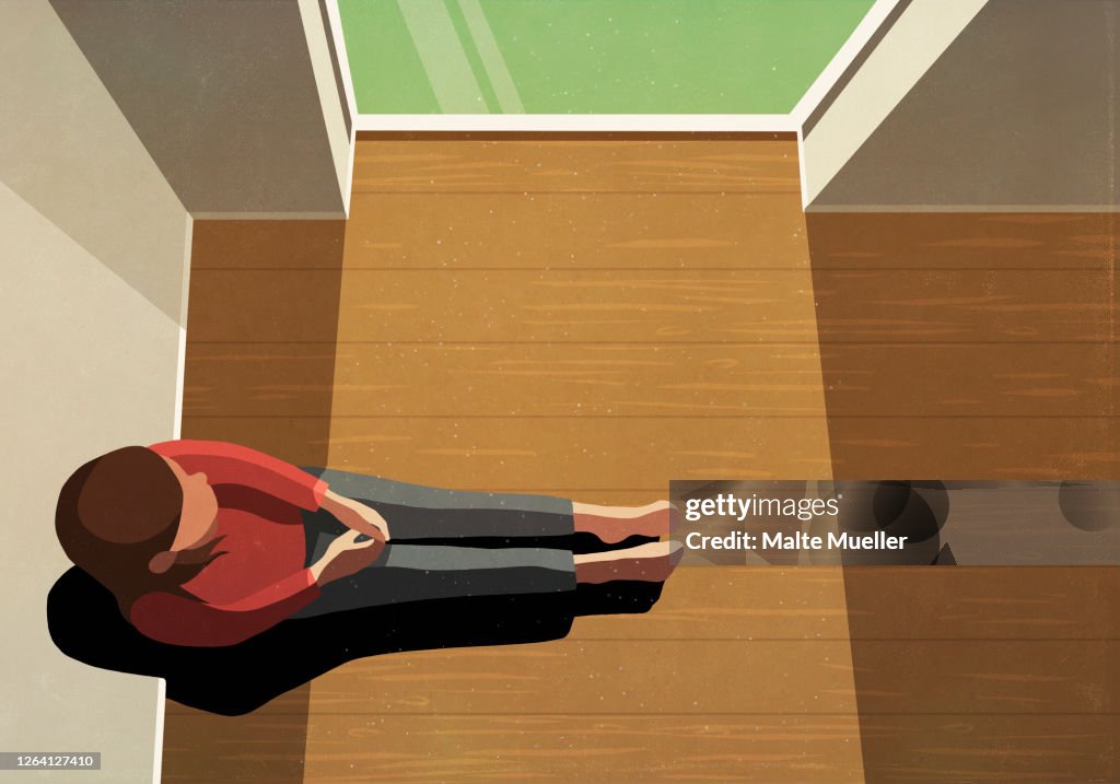 Lonely woman sitting in sunny window